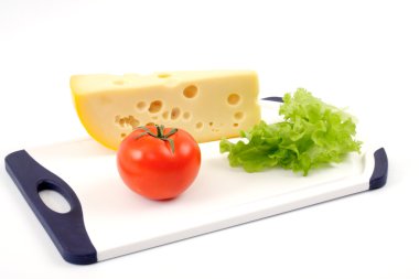 Cheese, tomato and salad sheet on a white board clipart