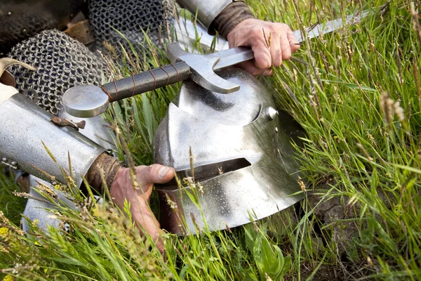 Strength and protection / knight's hands, helmet, sword — Stock Photo, Image