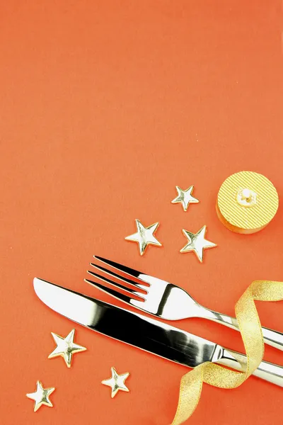 Knife and fork with ribbon, stars, candle — Stock Photo, Image