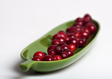 Cranberries in a leaf shape dish.