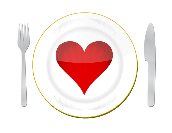 Coeur sur l'assiette avec fourchette et couteau — Photo
