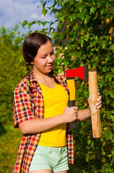 Young woman holding an axe and chock — Stock Photo, Image