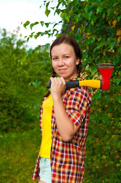 Young woman carrying an axe — Stock Photo, Image