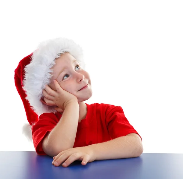 Menino em chapéu de Santa, olhando para copiar espaço — Fotografia de Stock
