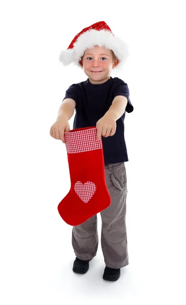 Ler pojke anläggning Julstrumpa framför honom — Stockfoto