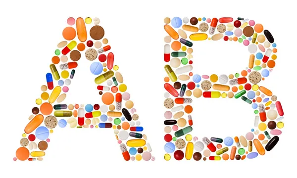 Znaky a b z barevných pilulek — Stock fotografie