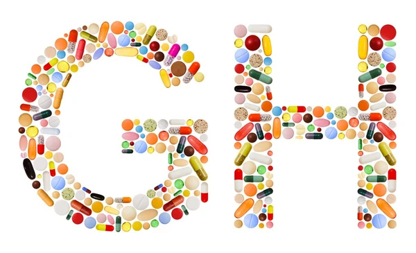 Tekens g en h gemaakt van kleurrijke pillen — Stockfoto