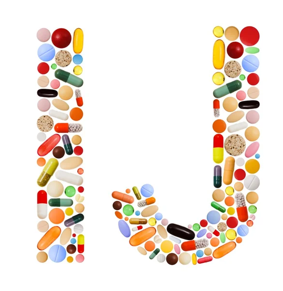 Znaki i oraz j wykonane z kolorowych tabletek — Zdjęcie stockowe