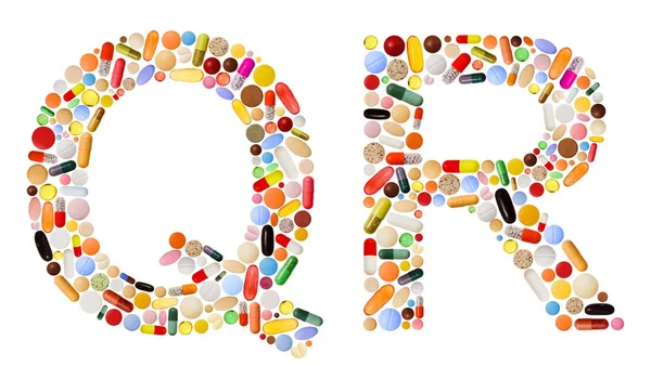 Znaky q a r z barevných pilulek — Stock fotografie