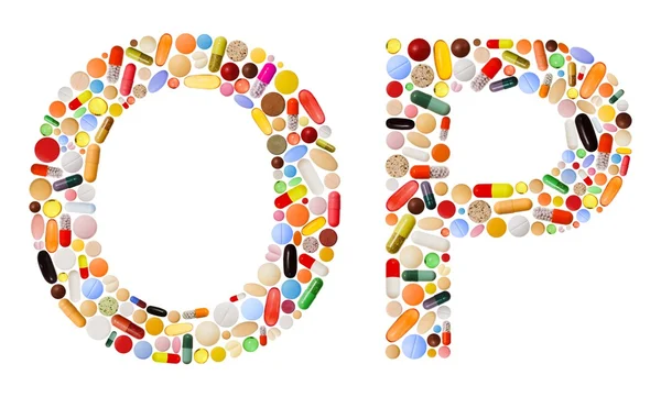 Znaki o i p wykonane z kolorowych tabletek — Zdjęcie stockowe