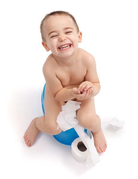 Happy little boy sitting on potty