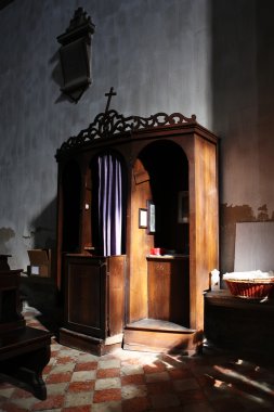 Christian confessional in mysterious light clipart