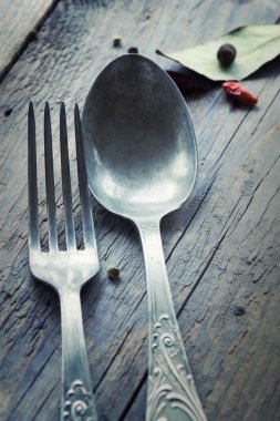 Fork and knife in rustic setting clipart