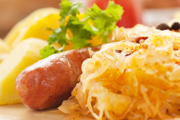 Sausage with potatoes and sauerkraut — Stock Photo, Image