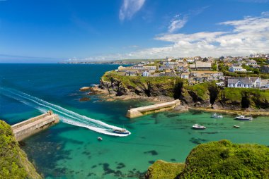 Cove and harbour of Port Isaac with arriving ship, Cornwall, England clipart