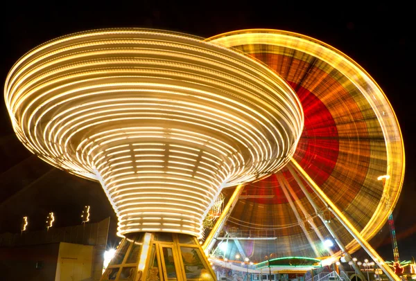 stock image Ferris wheel and carousel at county fair at night, Karlsruhe, Germany