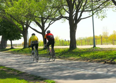 Bicycling in a park clipart