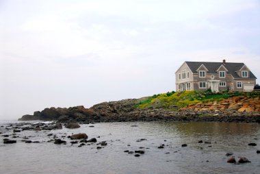 House on ocean shore clipart
