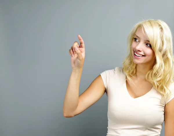 Happy young woman pointing — Stock Photo, Image