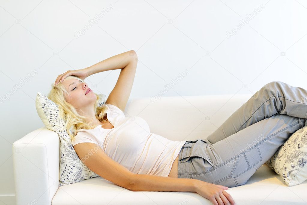 Tired woman laying on couch