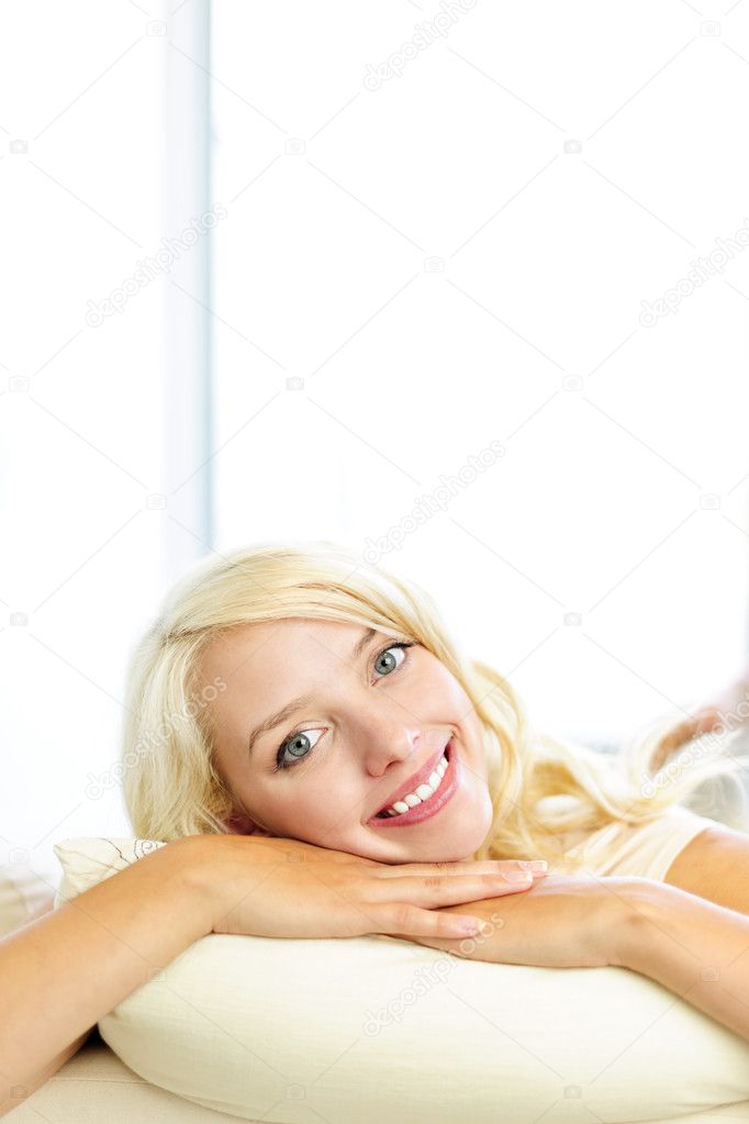 Smiling woman resting on cushion