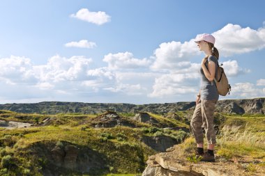 Hiker in badlands of Alberta, Canada clipart