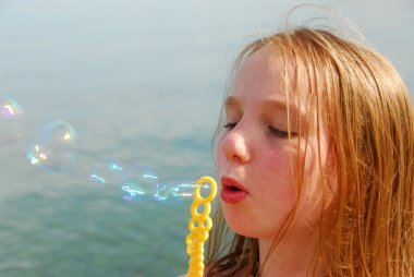 Girl blowing bubbles clipart