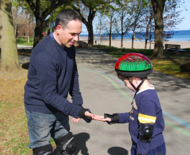 Father and son rollerblading clipart