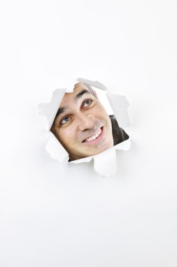 Face looking up through hole in paper clipart