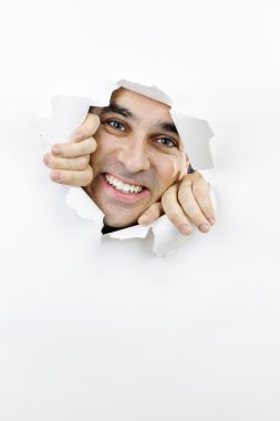Happy face looking through hole in paper clipart