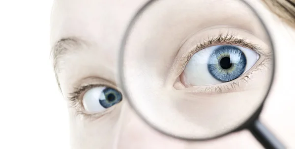 Eye looking thorough magnifying glass — Stock Photo, Image
