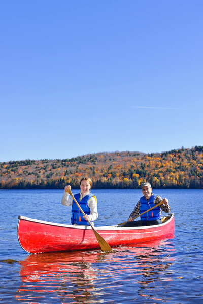 Canoe trip on scenic lake in fall