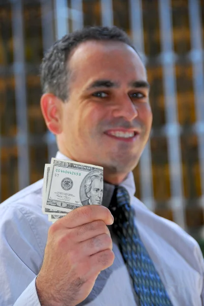 Podnikatel držet peníze — Stock fotografie