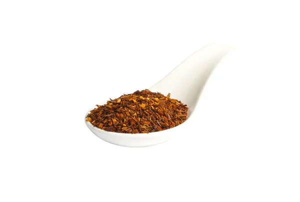 Spoon with loose Rooibos red tea, isolated — Stock Photo, Image