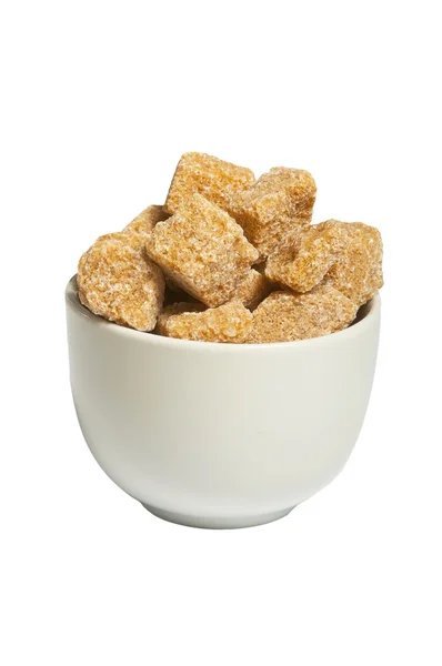 Cubes of organic whole cane sugar in bowl, isolated — Stock Photo, Image