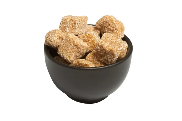 Cubes of whole cane sugar in bowl, isolated — Stock Photo, Image