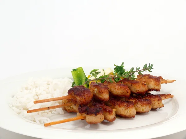 Grilled turkey kebabs on rice with salad — Stock Photo, Image