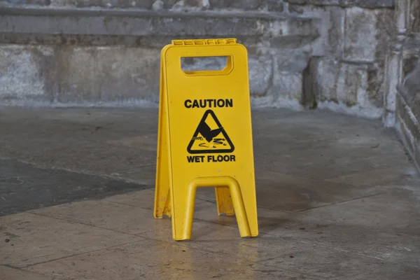 Yellow caution wet floor sign — Stock Photo, Image