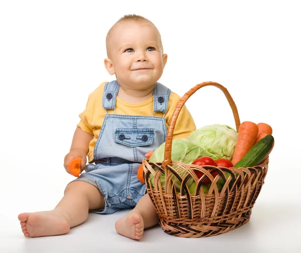 Söt liten pojke med korg full av grönsaker — Stockfoto