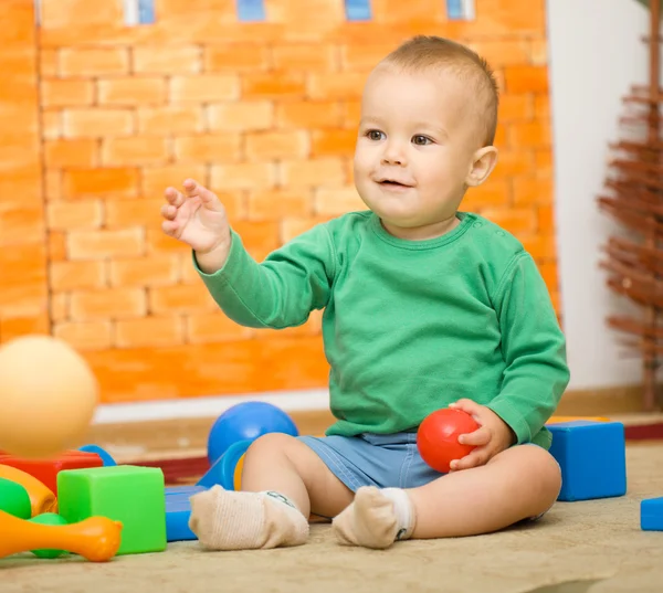 Маленький хлопчик грає з іграшками в дошкільному — стокове фото