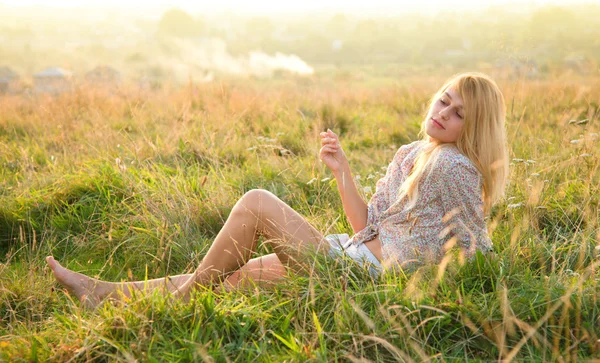 Girl is relaxing on green field — Stock Photo, Image