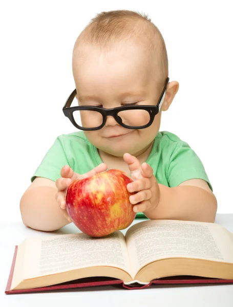 stock image Little child is playing with red apple