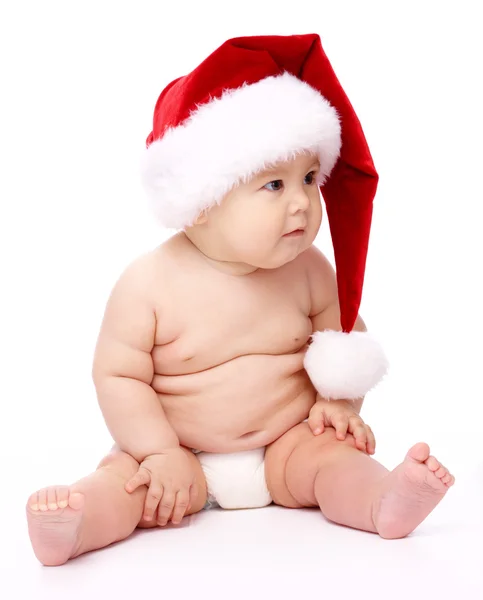 Little child wearing red Christmas cap Royalty Free Stock Images