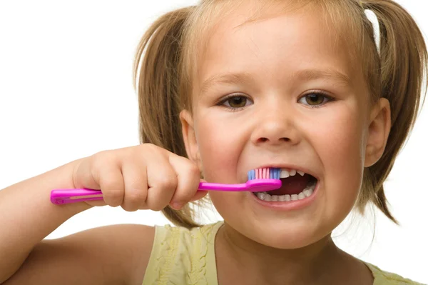 Little girl is cleaning teeth using toothbrush Royalty Free Stock Images