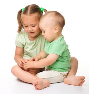 Two children are playing on the floor clipart