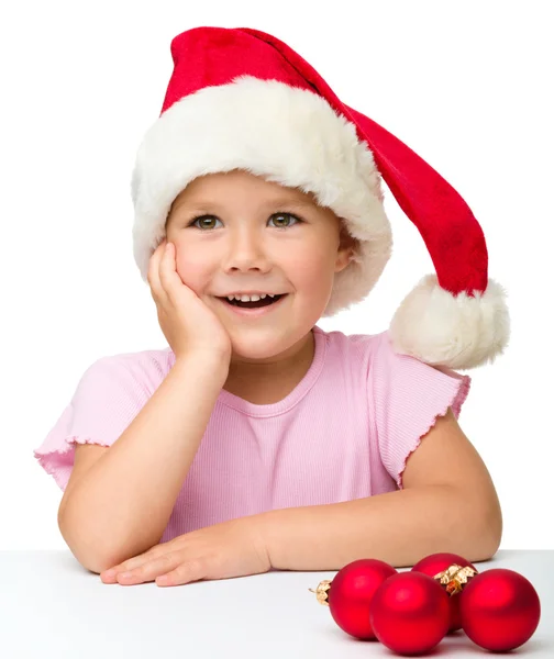 Niedliches kleines Mädchen mit Weihnachtsmütze — Stockfoto