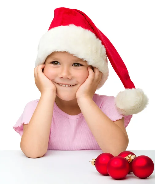 Cute little girl wearing santa hat — Stock Photo, Image