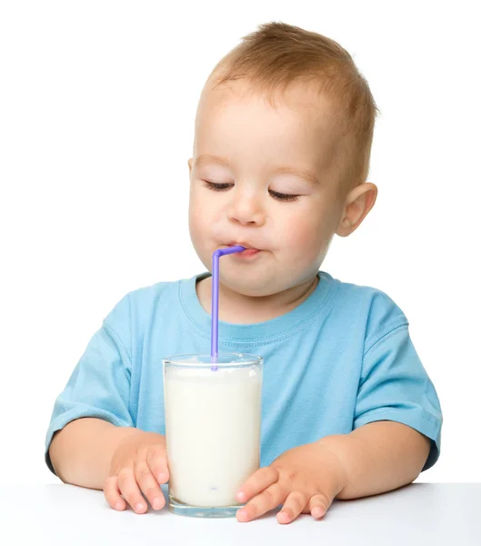 Cute little boy is drinking milk — Stock Photo, Image