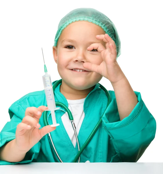 Menina está jogando médico com seringa — Fotografia de Stock
