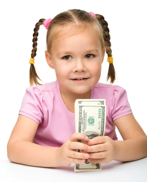 Cute little girl with paper money - dollars — Stock Photo, Image